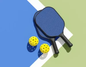 Pickleball paddles on the court with two balls