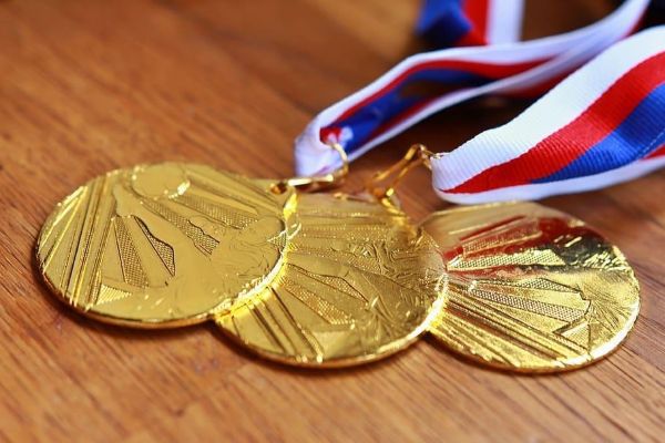 Three medals laid out on a table