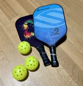 Pickleball paddles and balls on the floor