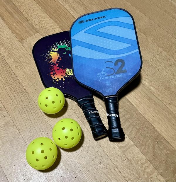 Pickleball paddles and balls on the floor